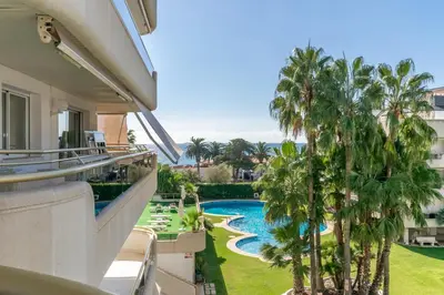 a view of the pool from the balcony of a resort at ESTRELLA DE MAR Sitges in Sitges