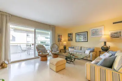 a living room with a couch and a table at ESTRELLA DE MAR Sitges in Sitges