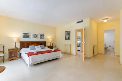 a large bedroom with a bed and a bathroom at ESTRELLA DE MAR Sitges in Sitges