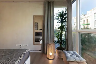 a bedroom with a black bed and a white wall at SONORA - Bright Apartment with view of Sagrada Familia in Barcelona