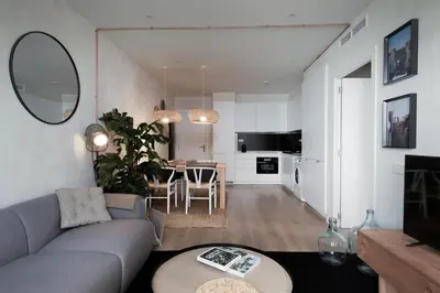 a bedroom with a bed and a potted plant at SONORA - Bright Apartment with view of Sagrada Familia in Barcelona