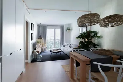 a table and chairs in a room with a picture on the wall at SONORA - Bright Apartment with view of Sagrada Familia in Barcelona