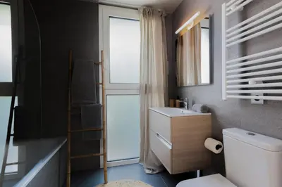 a living room with a gray couch and a mirror at SONORA - Bright Apartment with view of Sagrada Familia in Barcelona