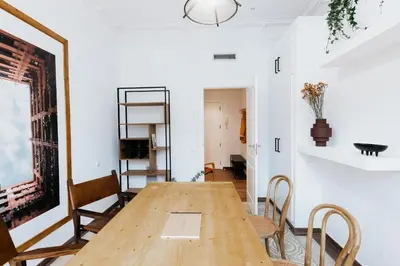 a room with white walls and a hallway with a table at LLANOS - Two Bedroom apartment in heart of the city in Barcelona