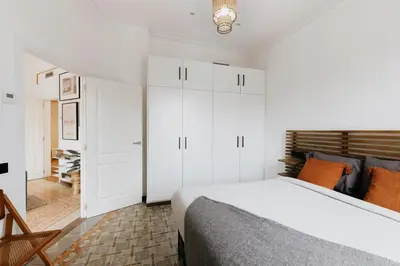 a living room with a green couch and a tv at LLANOS - Two Bedroom apartment in heart of the city in Barcelona