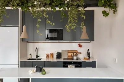 a kitchen with black cabinets and white counters at DENALI - Stylish apartment in center of Barcelona in Barcelona