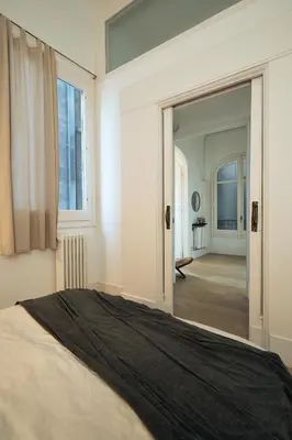 a living room with a green couch and chairs at SAPO - Two bedroom in the heart of Barcelona in Barcelona