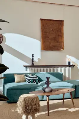 a living room with a green couch and a table at SAPO - Two bedroom in the heart of Barcelona in Barcelona