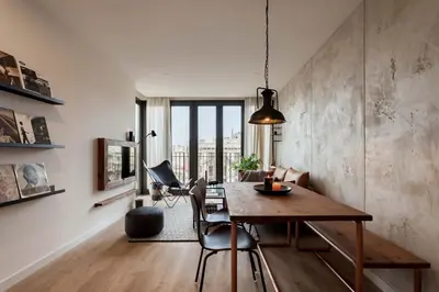 a candle on a table next to a wall with a mirror at NEVIS - Modern two bedroom apartment in Sagrada Familia in Barcelona
