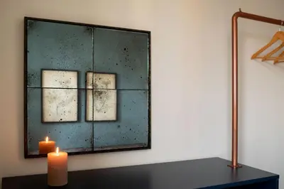 a table with a plant on it next to a chair at NEVIS - Modern two bedroom apartment in Sagrada Familia in Barcelona