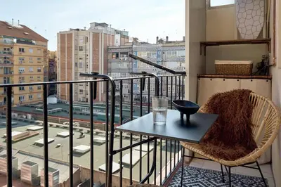 a table on a balcony with a view of a city at YANGRA - Two Bedroom Apartment in Consell de Cent in Barcelona