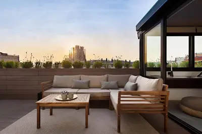a living room with a couch and a table at DOURO - Penthouse with a view of the Sagrada F. in Barcelona