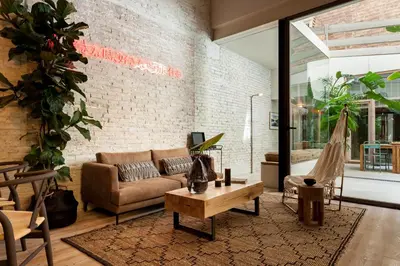 a dining room with tables and chairs and plants at AMAZONAS - Three bedroom duplex in Gracia in Barcelona