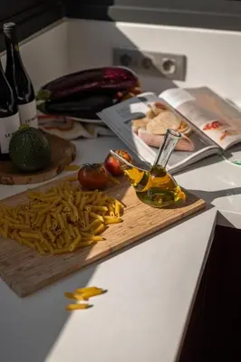 a kitchen counter with a cutting board with vegetables and oil at 4 BR vila 25 minutes to Barcelona Fantastic sea views pool in Alella