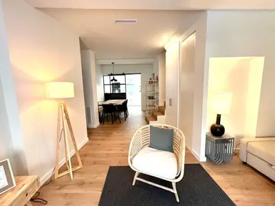 a living room with a chair and a couch at Hauzify I Apartaments Sant Pau in San Pol de Mar