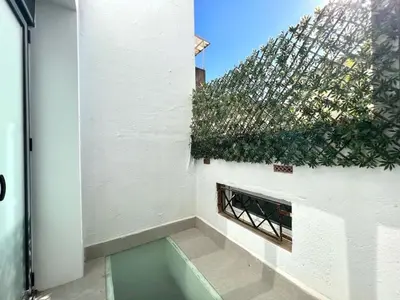 a view from the outside of a building with a fence at Hauzify I Apartaments Sant Pau in San Pol de Mar