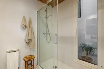 a bed in a room with white shelves at HIDALGO - Two bedroom apartment in Eixample in Barcelona