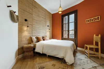 a kitchen with a wooden table and chairs at HIDALGO - Two bedroom apartment in Eixample in Barcelona
