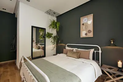 a bedroom with a bed and a green wall at ERAWAN - One bedroom apartment in Eixample in Barcelona