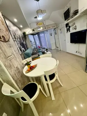 a white table and chairs in a living room at BADAROSA House Badalona next to Barcelona & beach in Badalona