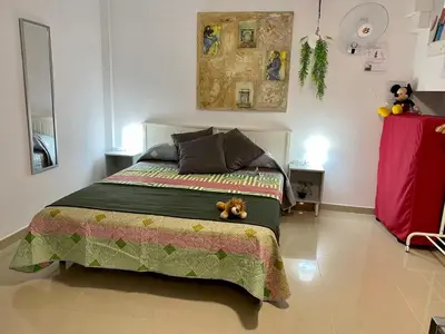 a bedroom with a bed with a teddy bear sitting on it at BADAROSA House Badalona next to Barcelona & beach in Badalona