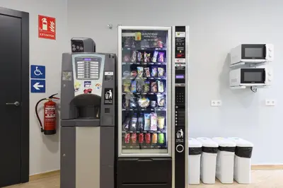 a soda vending machine in a store with drinks at Hey Rooms in Cerdanyola del Valles
