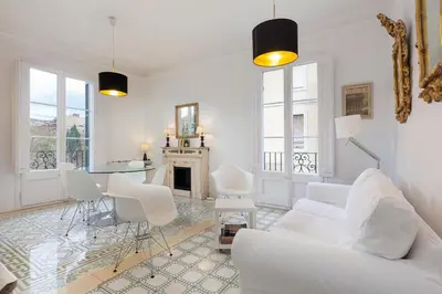 a living room with a white couch and a table at Sagrada Familia 4 Bedrooms 