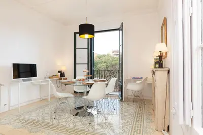 a white living room with a table and chairs at Sagrada Familia 4 Bedrooms 