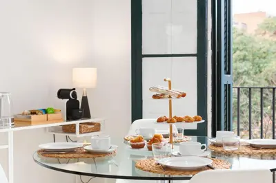 a glass table with food on it in a room with a window at Sagrada Familia 4 Bedrooms 