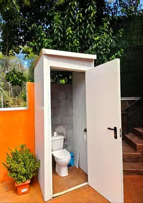 a bathroom with a toilet in a shed at Relax House Barcelone in Sant Esteve Sesrovires
