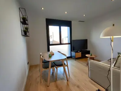 a living room with a table and a couch at Stylish apartments Camp Nou in Hospitalet de Llobregat