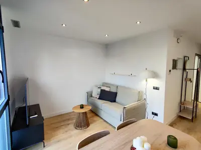 a living room with a couch and a table at Stylish apartments Camp Nou in Hospitalet de Llobregat