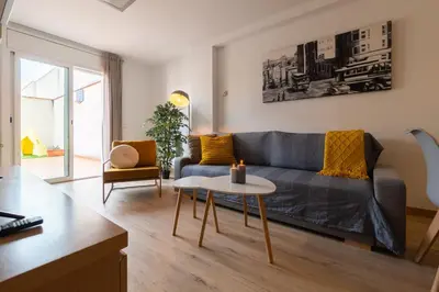 a living room with a couch and a table at Apartamento con gran patio y excelente ubicación! in Mataró