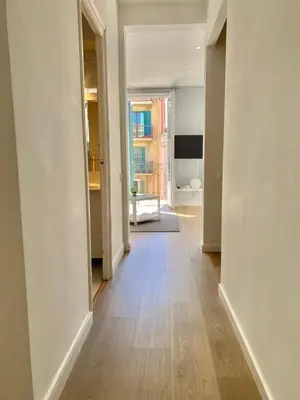 an empty hallway of an apartment with a wooden floor at 2 BDR EIXAMPLE APARTMENT in Barcelona