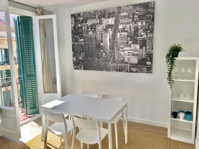 a white dining room with a white table and chairs at 2 BDR EIXAMPLE APARTMENT in Barcelona