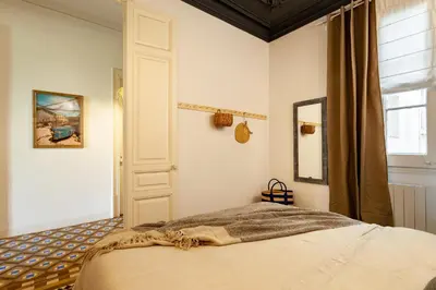 a living room with a kitchen and a living room with a table at LEGE - Two bedroom apartment in Mallorca St in Barcelona