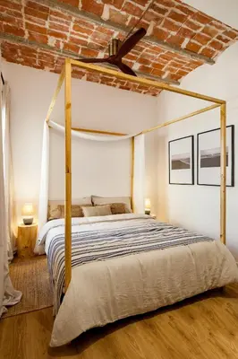 a living room with a couch and a brick wall at LEBLON - Two Bedroom Apartment in Eixample in Barcelona