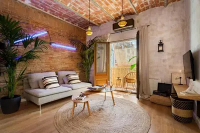 a bedroom with a canopy bed in a white room at LEBLON - Two Bedroom Apartment in Eixample in Barcelona