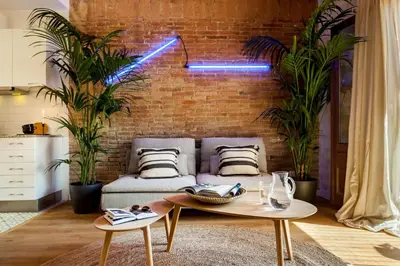 a kitchen with white cabinets and a brick wall at LEBLON - Two Bedroom Apartment in Eixample in Barcelona