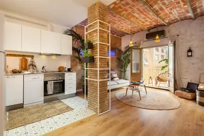 a living room with a table and a large window at LEBLON - Two Bedroom Apartment in Eixample in Barcelona