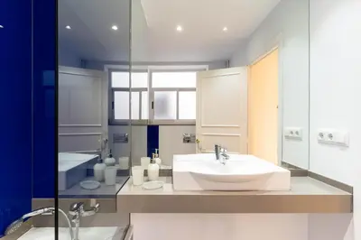 a bathroom with a sink and a mirror at SibsBcn-Paseo de Gracia Luxury Exclusive Gaudí in Barcelona