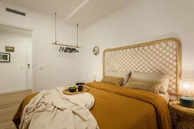 a bedroom with a large bed with a large headboard at TAMAN - Three Bedroom Apartment in Casanova Street in Barcelona