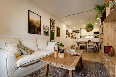 a balcony with a chair and a table and a building at TAMAN - Three Bedroom Apartment in Casanova Street in Barcelona