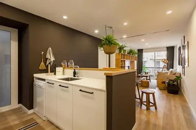 a room with a wooden desk with plants on the wall at TAMAN - Three Bedroom Apartment in Casanova Street in Barcelona