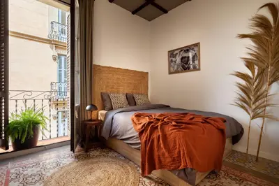 a bedroom with a bed and a mirror at NANAY - Two bedroom apartment in Gracia in Barcelona
