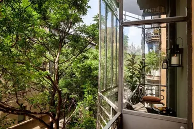 an open window with a view of a tree at PARU - Two Bedroom Apartment in Gracia in Barcelona