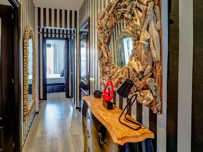 a hallway with a mirror and a wooden table at Flamingo Apartment by Hello Homes Sitges in Sitges