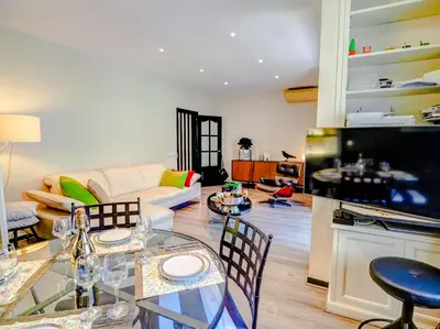 a living room with a glass table and chairs at Flamingo Apartment by Hello Homes Sitges in Sitges