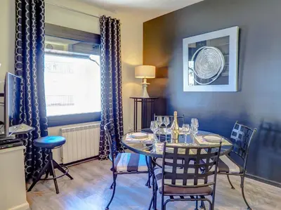 a dining room with a table and chairs and a window at Flamingo Apartment by Hello Homes Sitges in Sitges