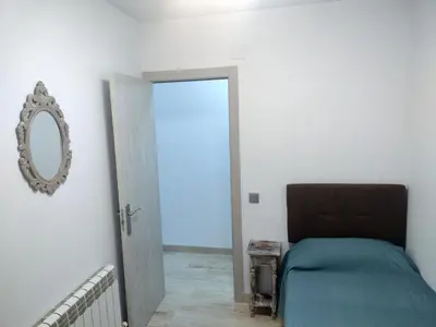 a bedroom with a bed and a mirror on the wall at Mar & Cunit in Cunit
